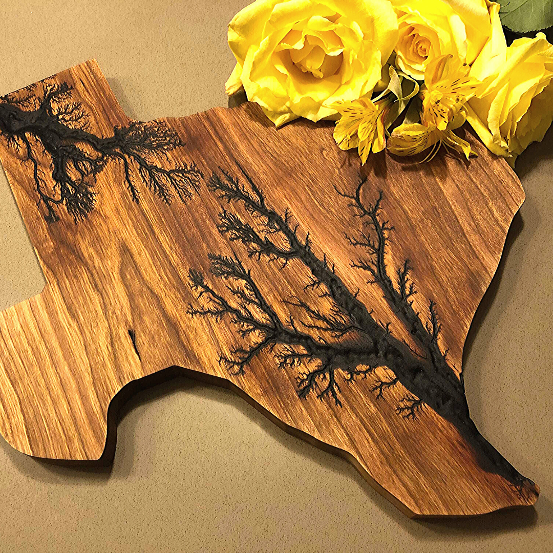 Texas shaped cheese board with yellow roses on the top right corner.