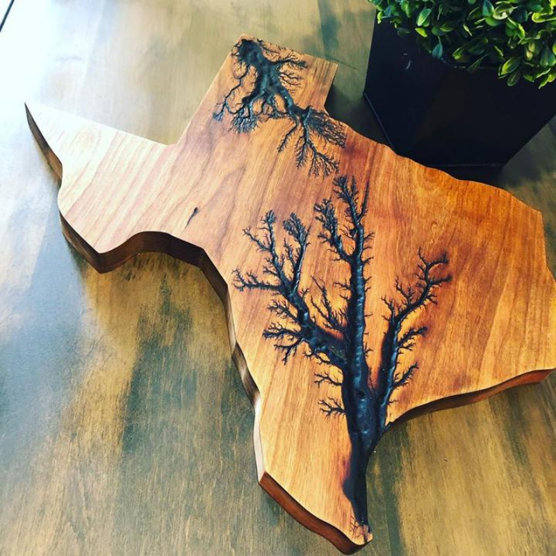 texas shaped charcuterie board on a table with a plant in the background. 